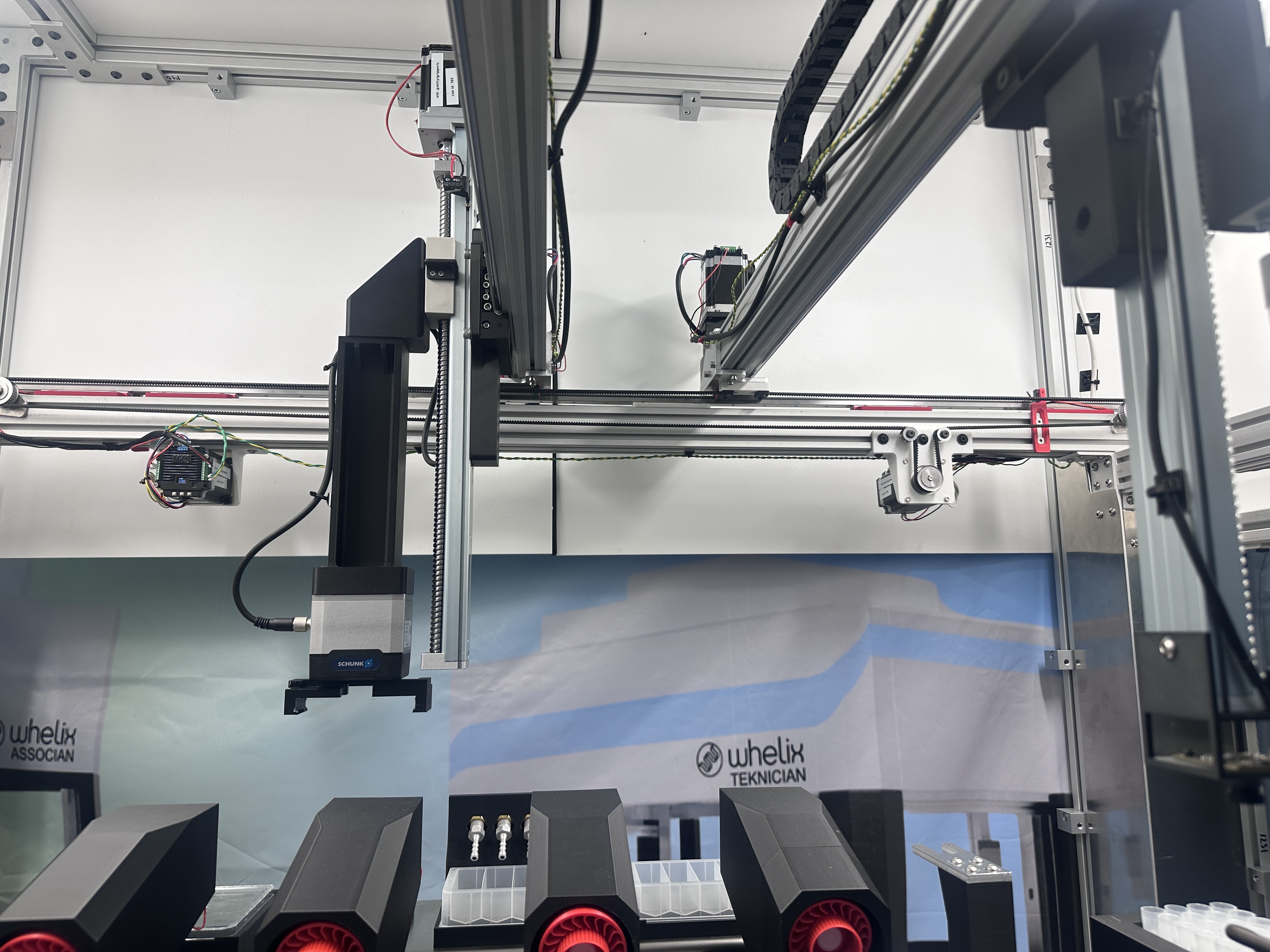 Close-up of Teknician robotic gantry arm with Associan and Teknician labels